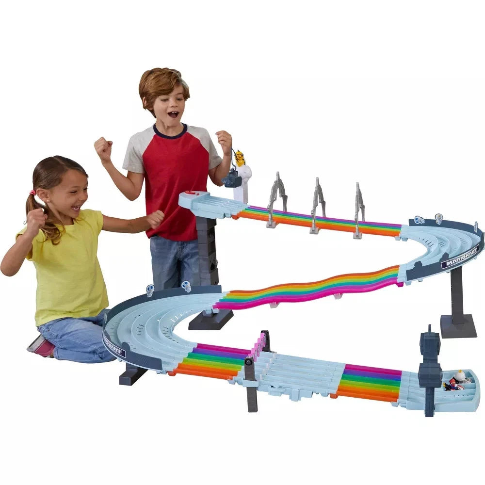 Children playing with a toy track set on a white background