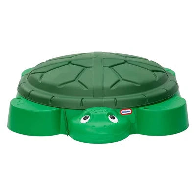 Green turtle-shaped playground equipment on a white background